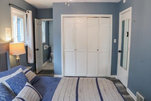 Master bedroom with queen-sized bed, private bathroom, closet space and a flat-screen TV