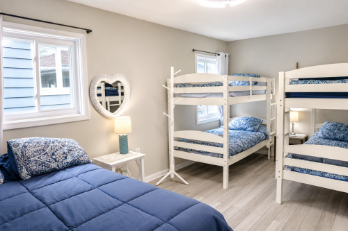 Second bedroom with a queen-sized bed and two sets of twin bunk beds. 