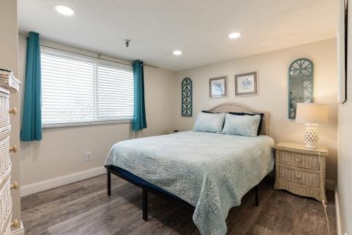 Third bedroom with a queen-sized bed and a window