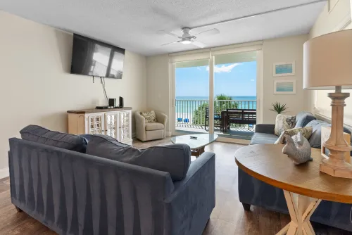 Living area with plenty of seating, flat-screen TV, and front ocean view