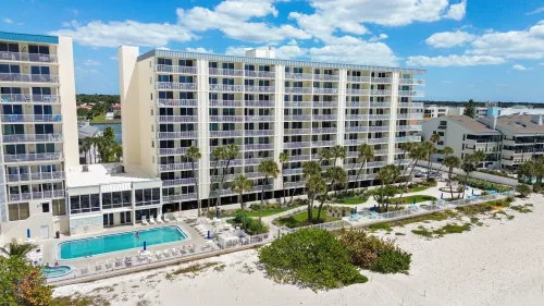 Beautiful landscaping, heated pool, hot tub, gas grills plenty of seating back of the building facing the ocean