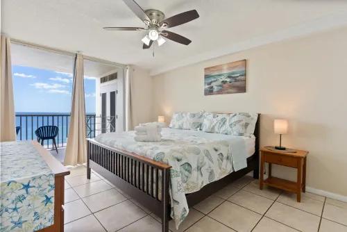 Master bedroom king bed overlooking balcony and ocean