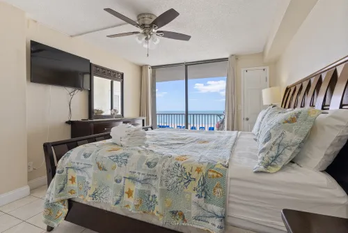Direct ocean front view from master bedroom with king-size bed