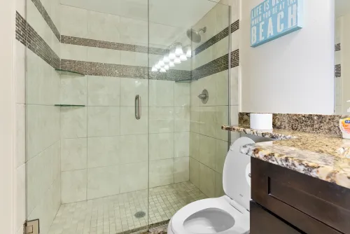 Master bedroom bathroom with granite walk-in tile shower 