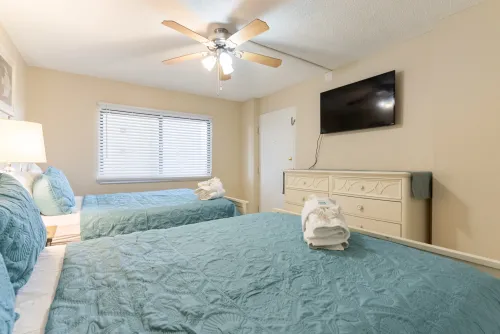 Second bedroom, two-queen beds with flat-screen TV and closet space