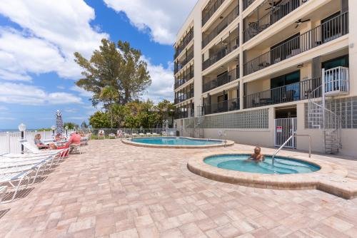 Private spiral staircase leading down to heated pool, hot tub gas grills plenty of seating by the pool