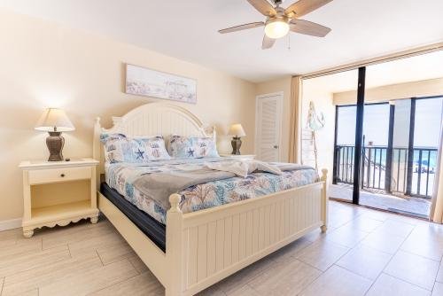 Master bedroom with king-sized bed along with a balcony and ocean view